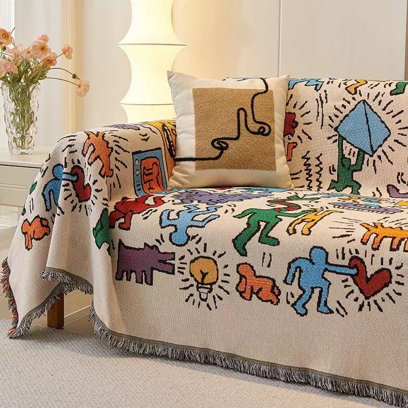 Funky cotton blanket used as a wall tapestry with abstract human and animal shapes
