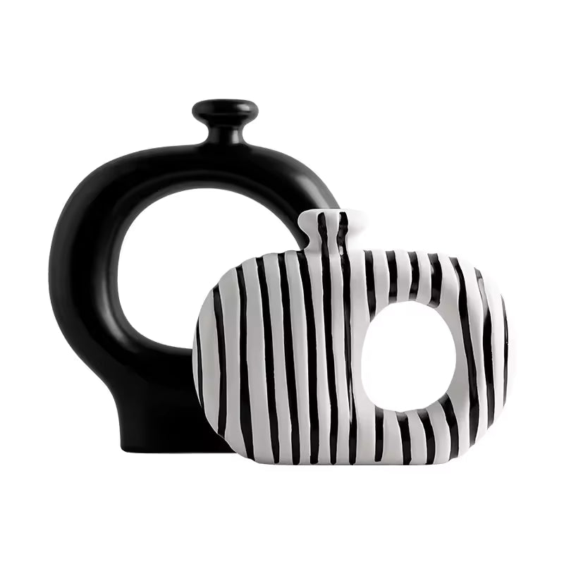 Black and white ceramic vase with abstract design on a white background