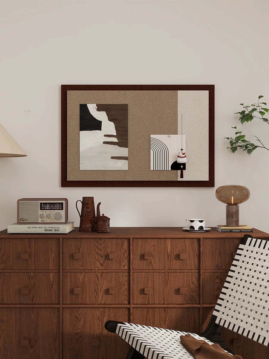 Brown and cream photo board displayed above a wooden dresser