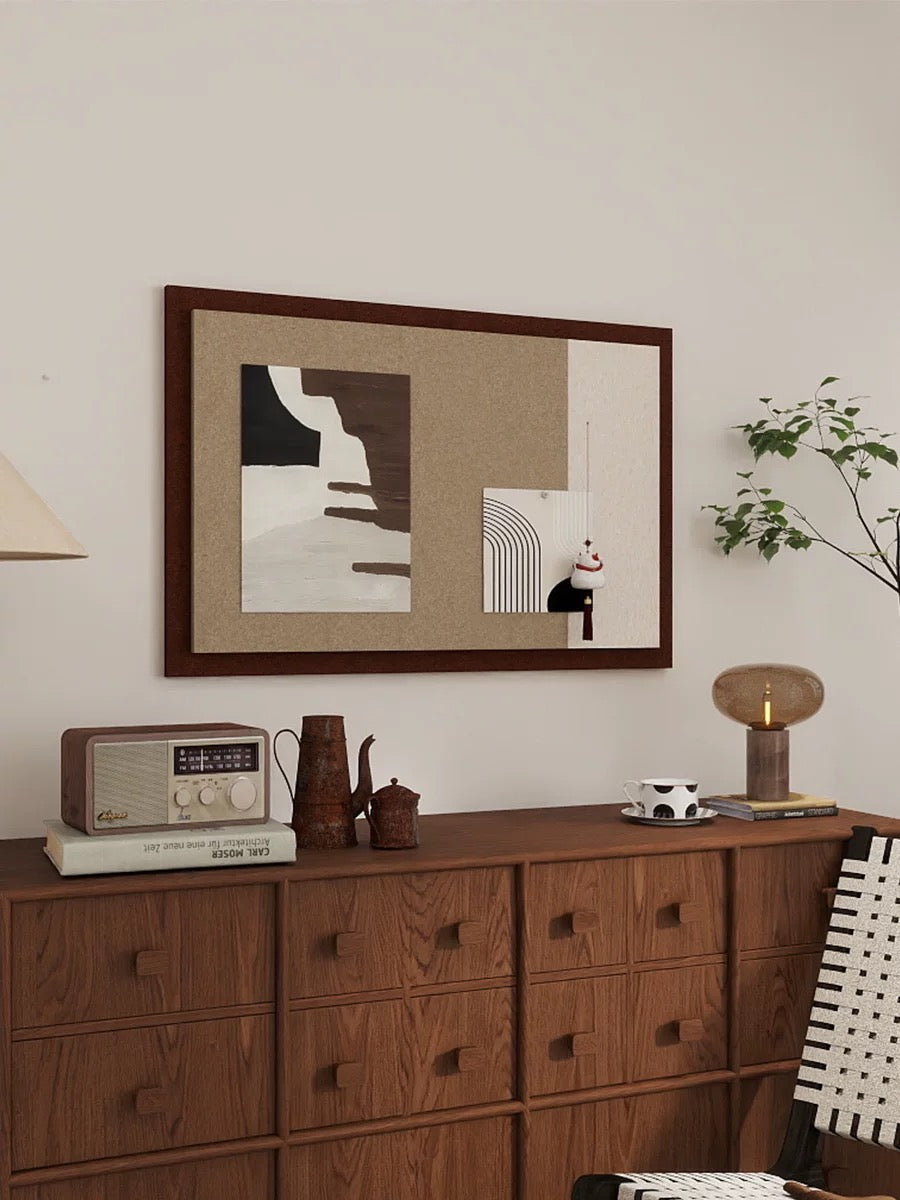 Brown felt pin board with cream geometric design above a dresser