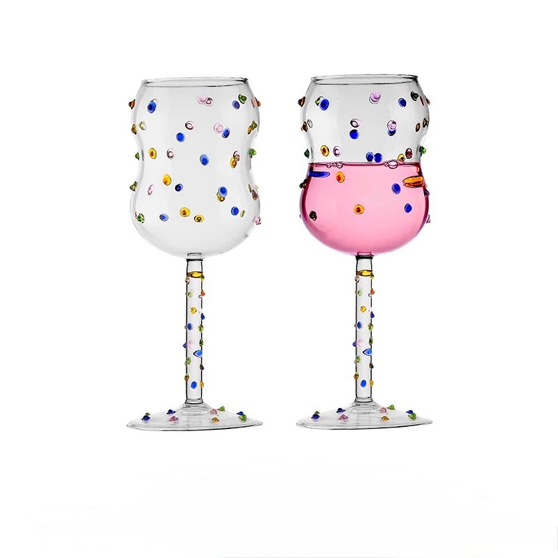 Two polka-dotted wine glasses on a white background