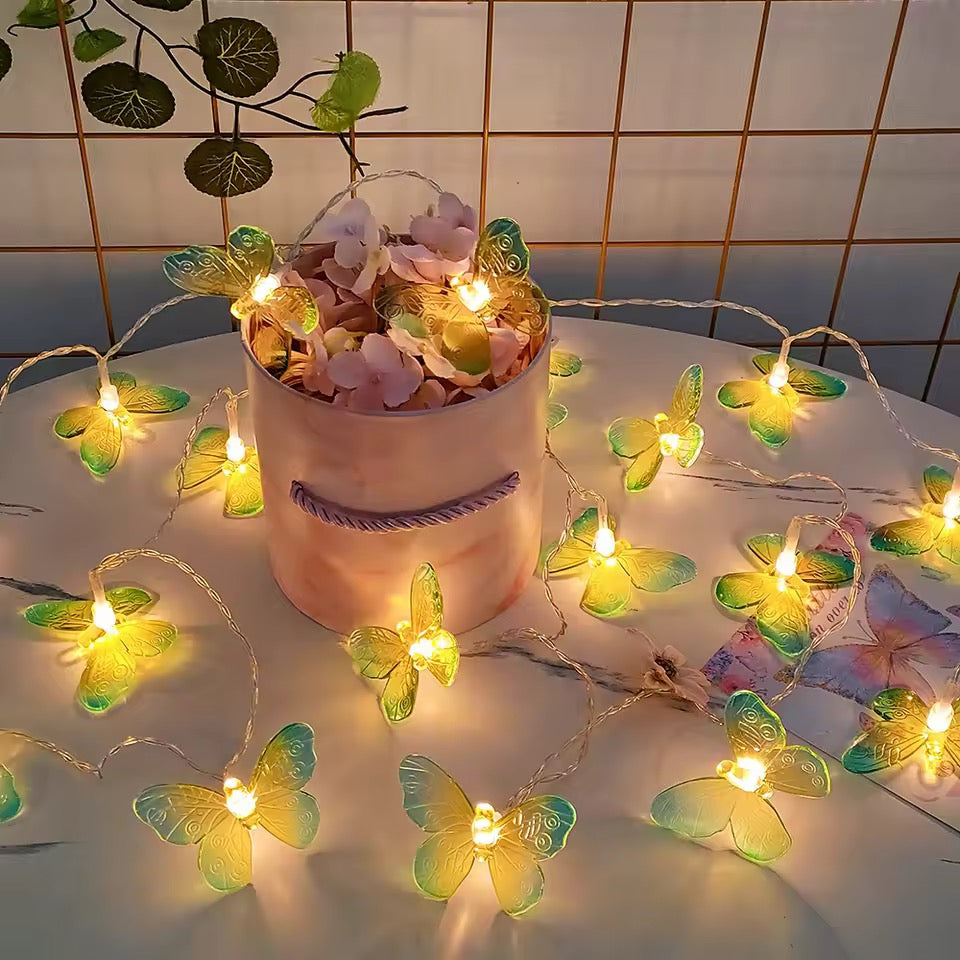 Butterfly string lights with a decorative pot of flowers on a tiled wall background