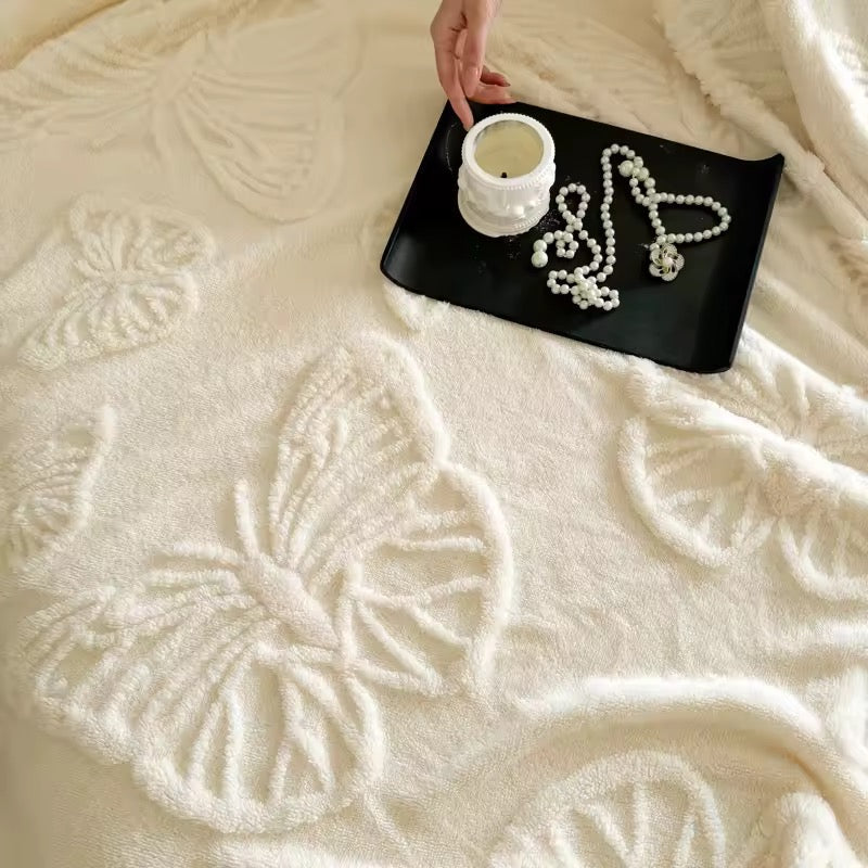Cozy white flannel blanket with embossed butterfly design