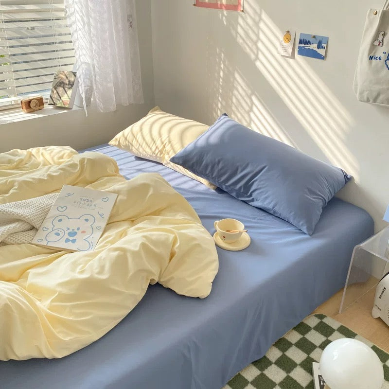 Pastel bedding styled with natural sunlight, creating a dreamy aesthetic college room.