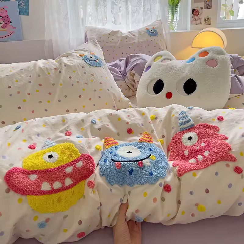 Close-up of embroidered cartoon monster details on kawaii cotton duvet cover.