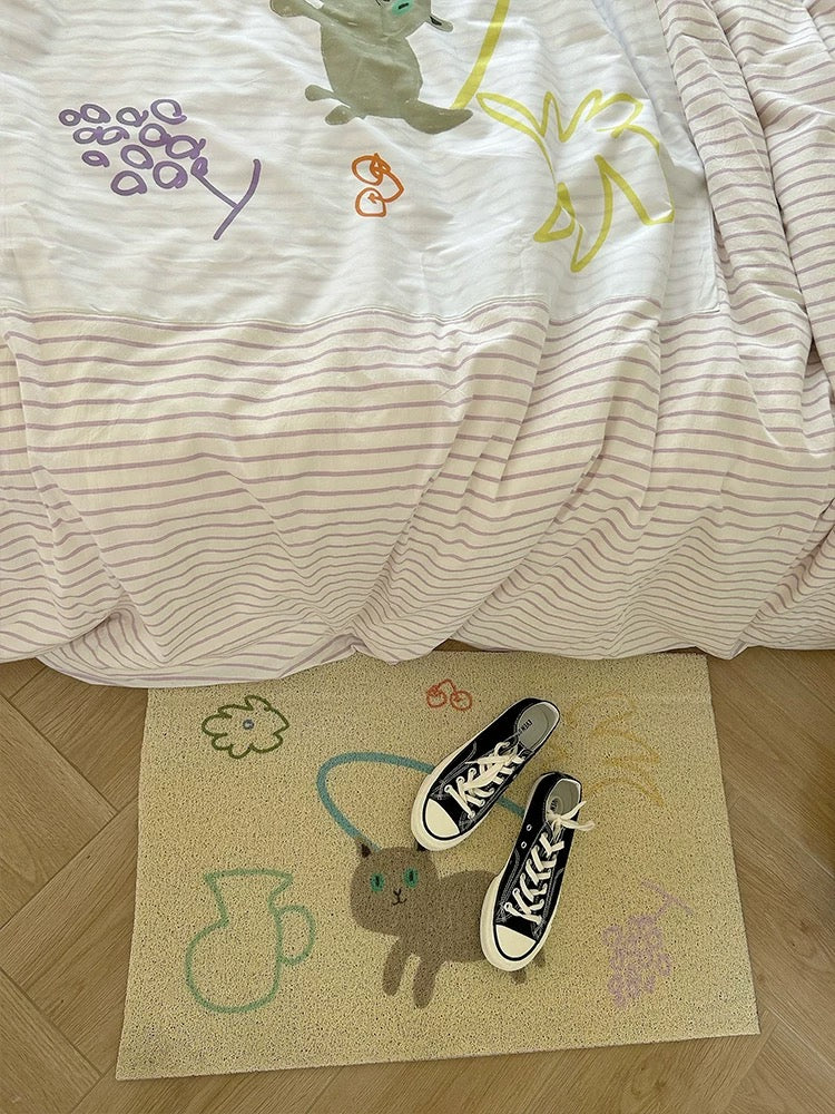 Close-up of the duvet cover with colorful cartoon applique motifs over narrow purple stripes.