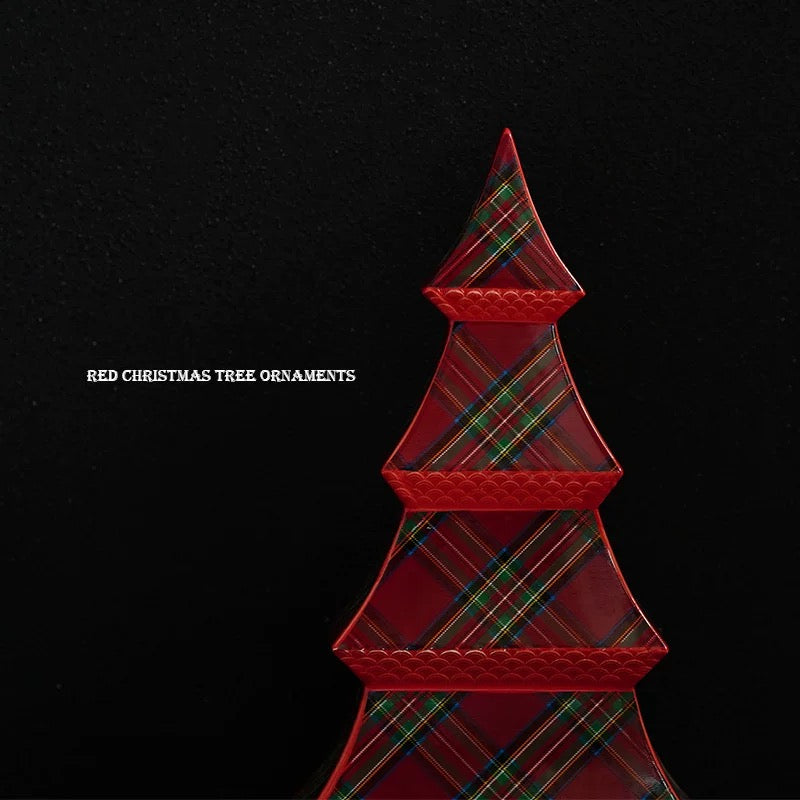 A ceramic tree figurine has red scalloped tier edges framing diagonal green and blue plaid lines.