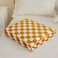 Gingham checkered blanket for a retro-inspired living room aesthetic