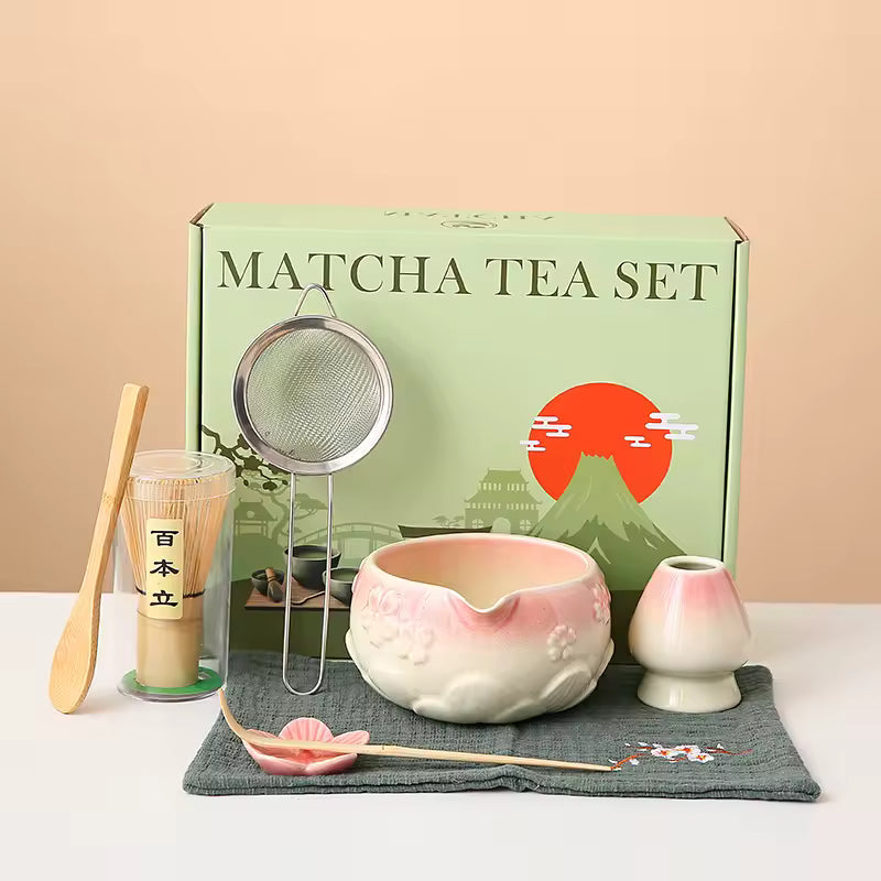 Matcha tea set with a green box featuring a mountain and sun design on a beige background.