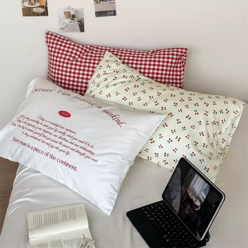Aesthetic cherry cotton pillowcase styled in a soft girl bedroom with pastel decor.
