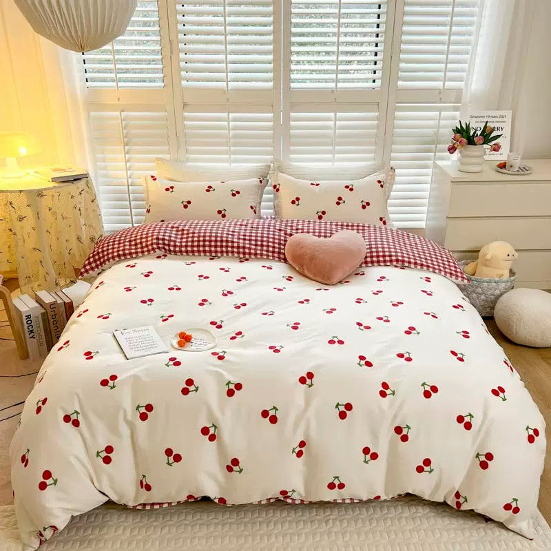 Cozy cherry duvet cover set styled with matching pillowcases for dorm rooms.