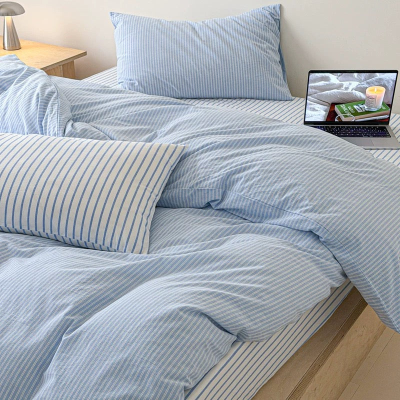 Scandinavian cotton bedding in light blue displayed with subtle striped texture and clean modern interior styling beautifully.