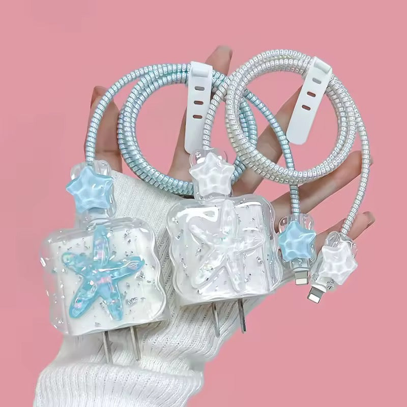 Starfish-shaped phone chargers with coiled cables on a pink background