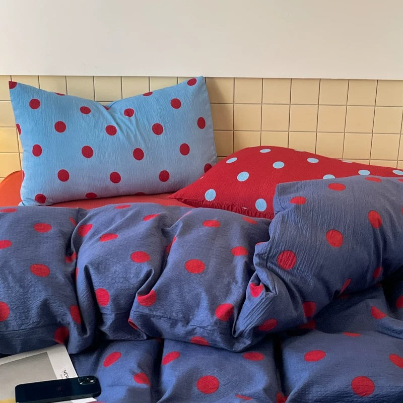 Blue polka dot duvet cover set styled in small dorm room cozy aesthetic setup