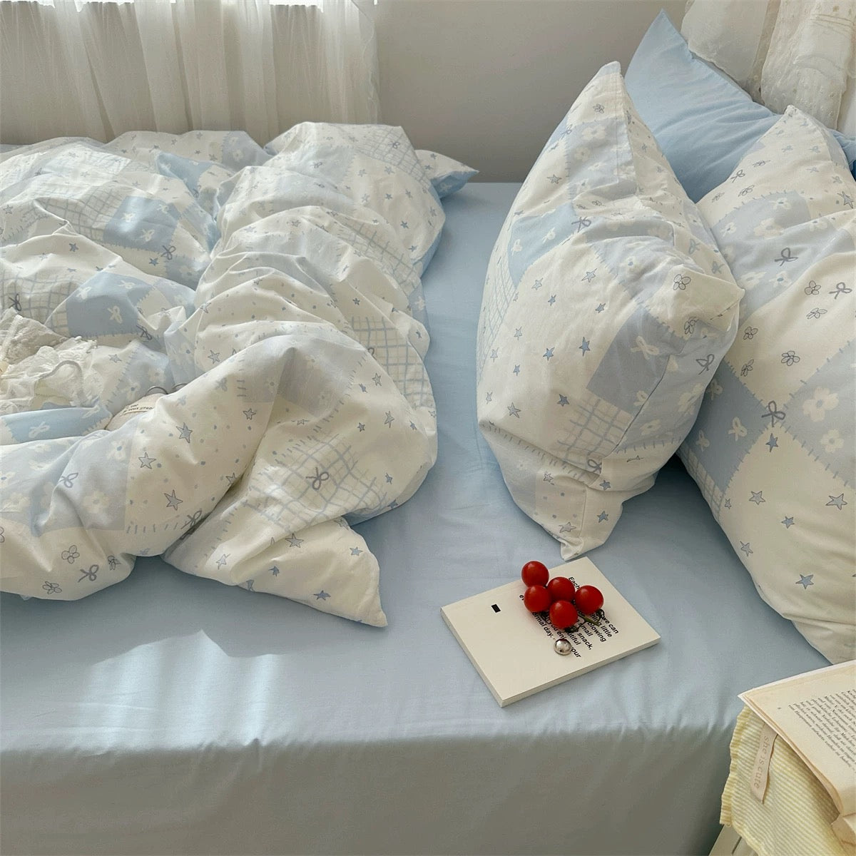 Aesthetic pastel bedding set with blue patchwork cotton duvet cover on queen bed.