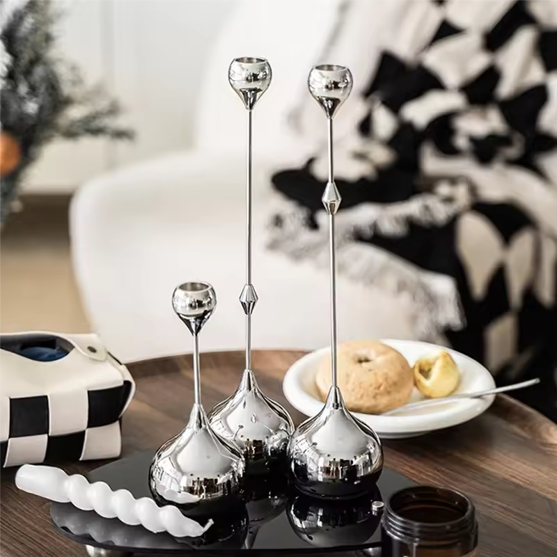 Set of silver candle holders on a table with a blurred background