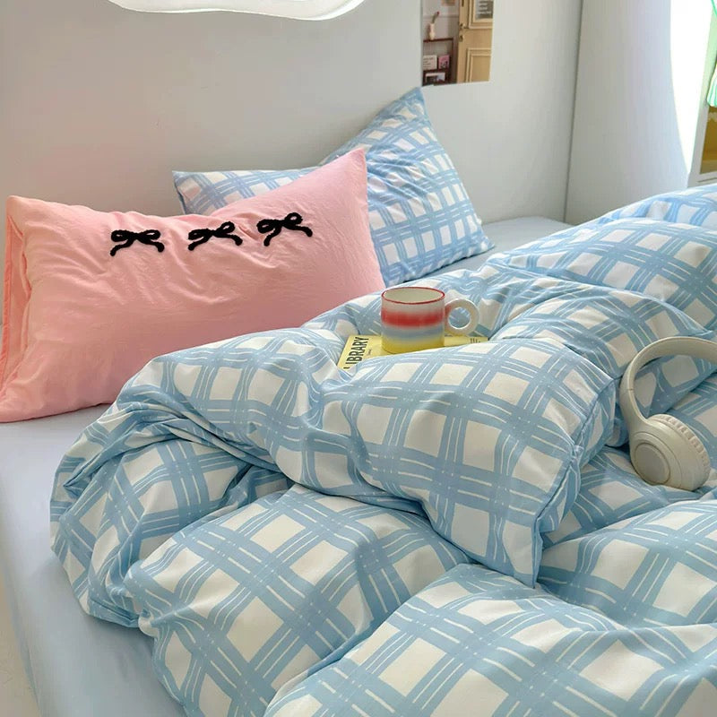 Aesthetic sky blue checked bedding styled with pink bows pillow – perfect for Korean dorm rooms
