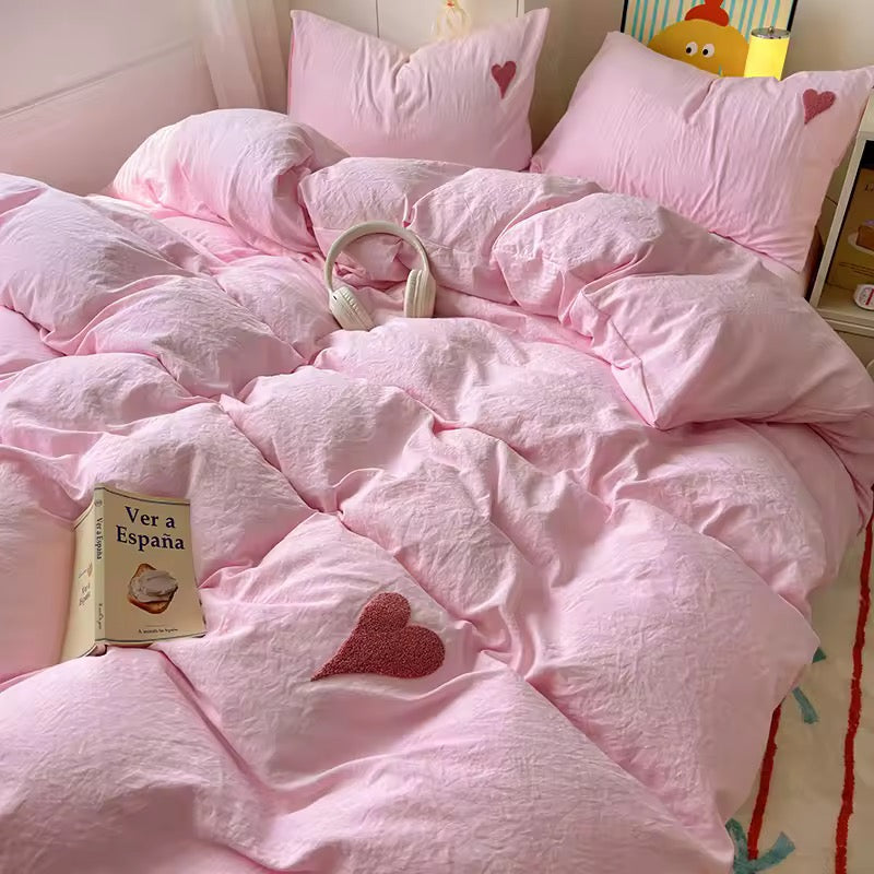 Cozy cotton bedding styled with pastel decor and cute accessories