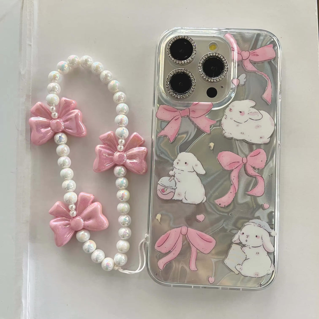 Coquette-inspired pink iPhone case with bunny and stars