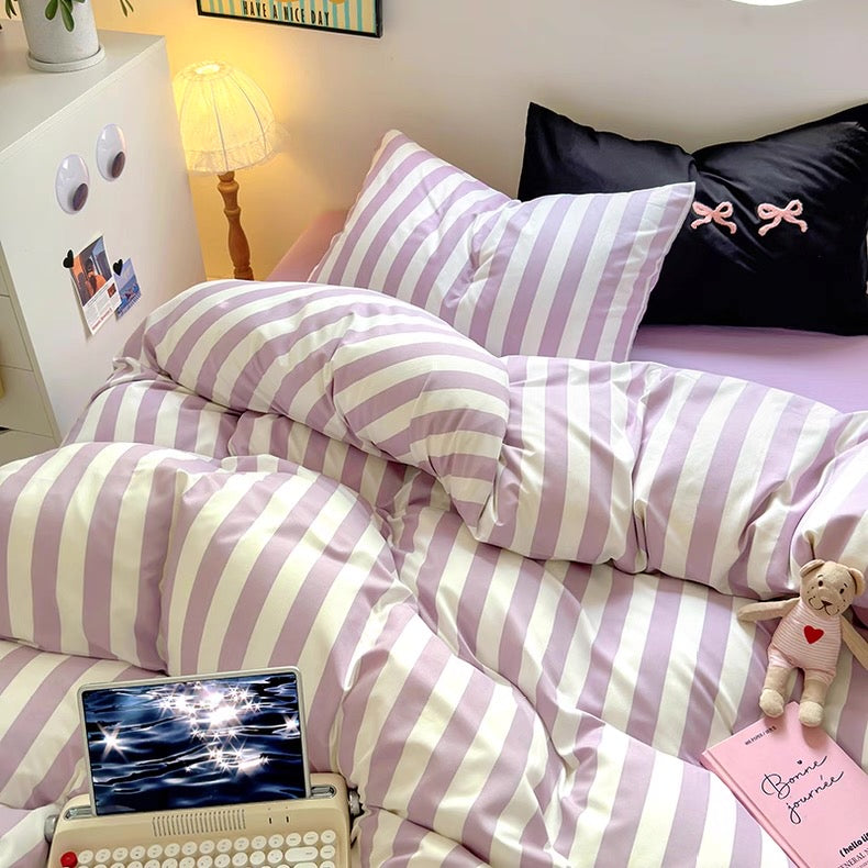 Coquette-inspired bedroom featuring the purple striped bedding set with pastel decor accents