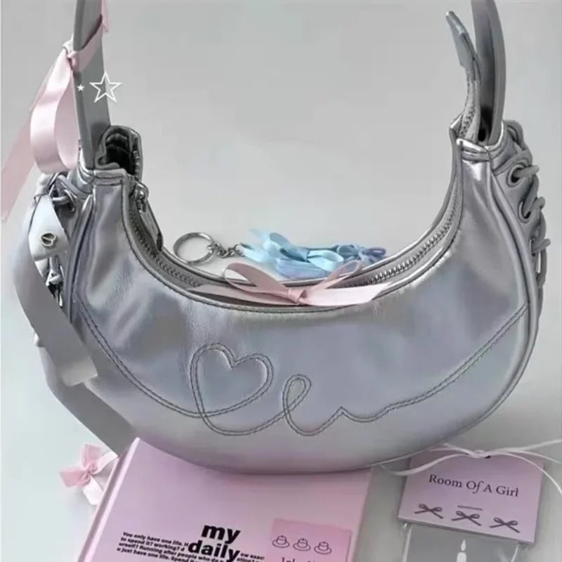 Balletcore half-moon silver handbag with Y2K aesthetic. Perfect coquette accessory for women’s vintage-inspired outfits.