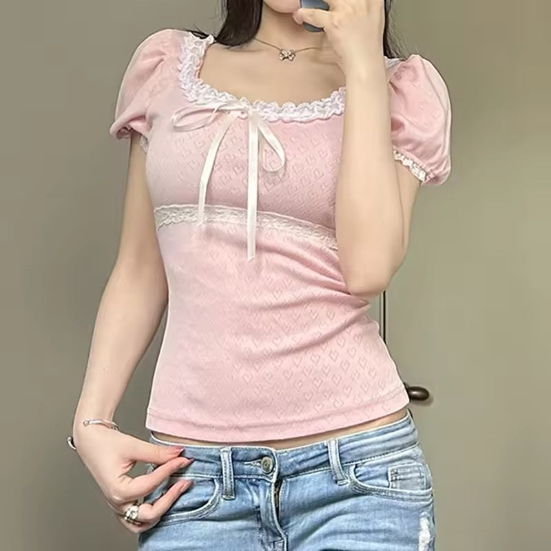 Cottagecore-inspired pink blouse with a cute bow and lace finish