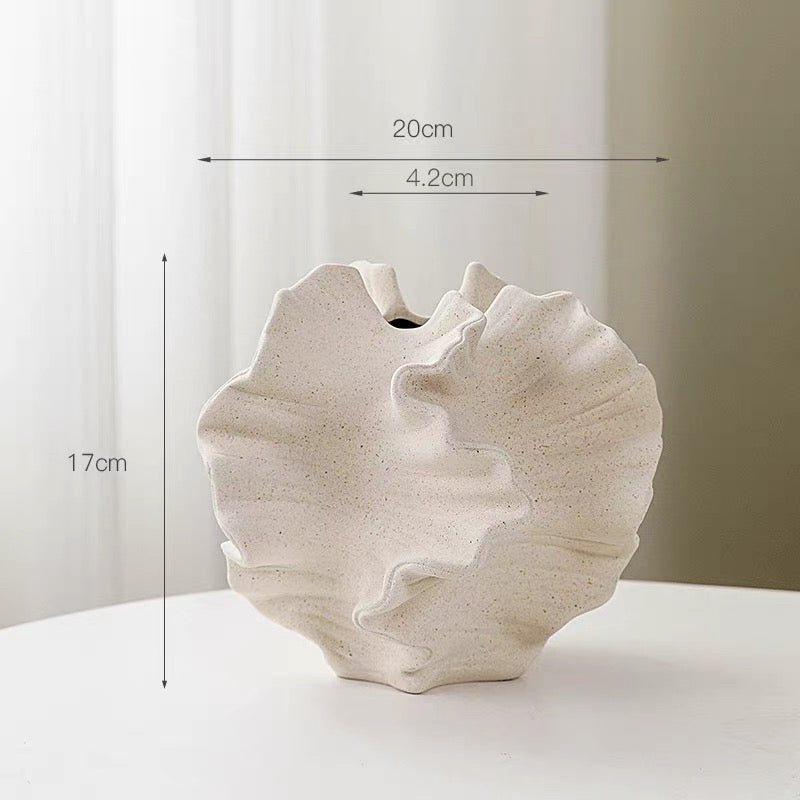White shell-shaped vase with dimensions on a white background