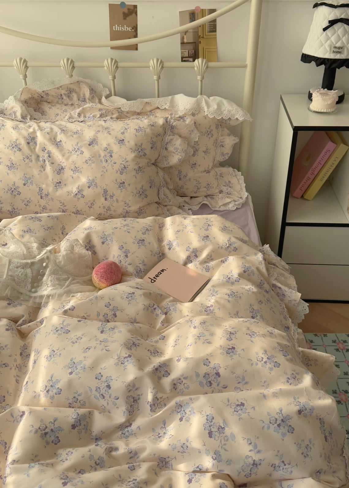 Floral bedding set on a bed with a nightstand in the background