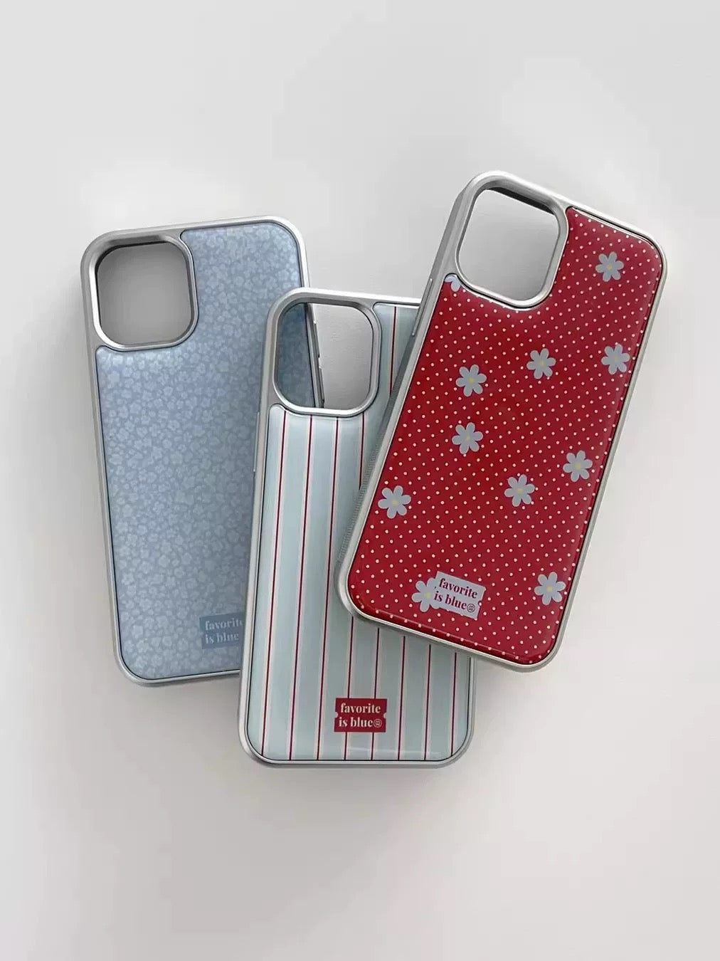 Three phone cases with different designs on a light gray background