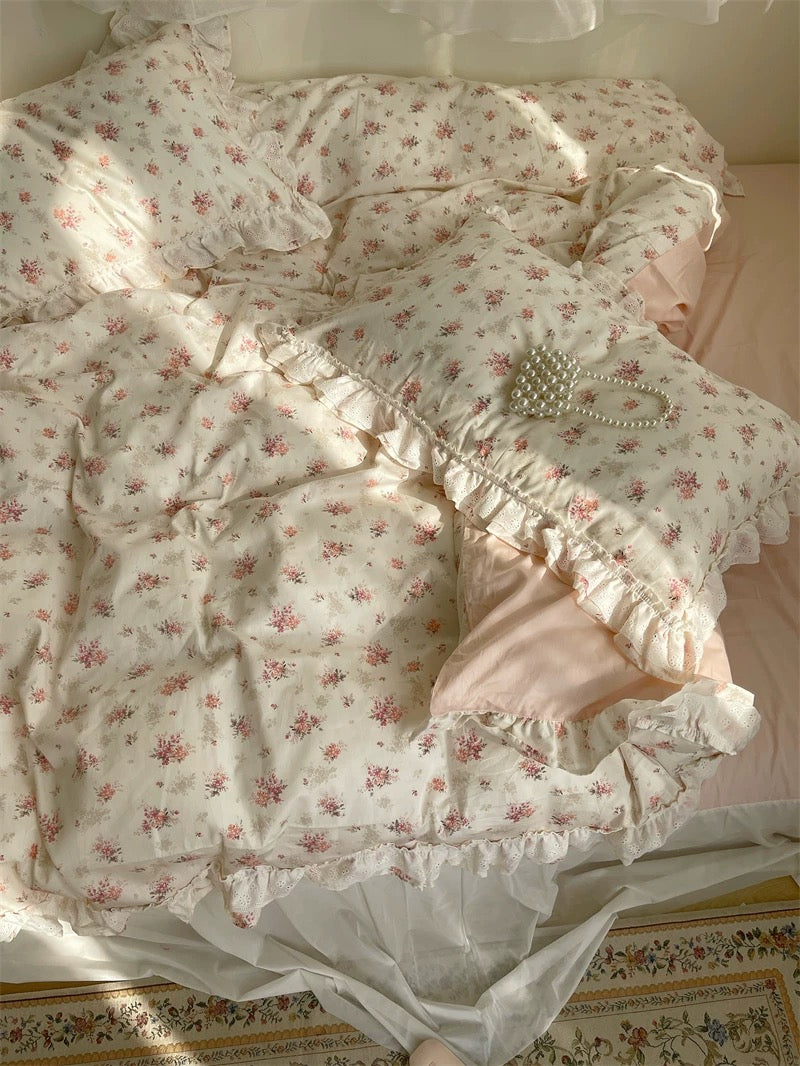 Queen-size pastel floral duvet with lace ruffles styled in cottagecore bedroom