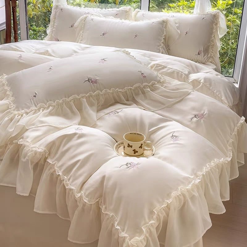 Cottagecore rose duvet cover with pink floral embroidery and decorative ruffle trim