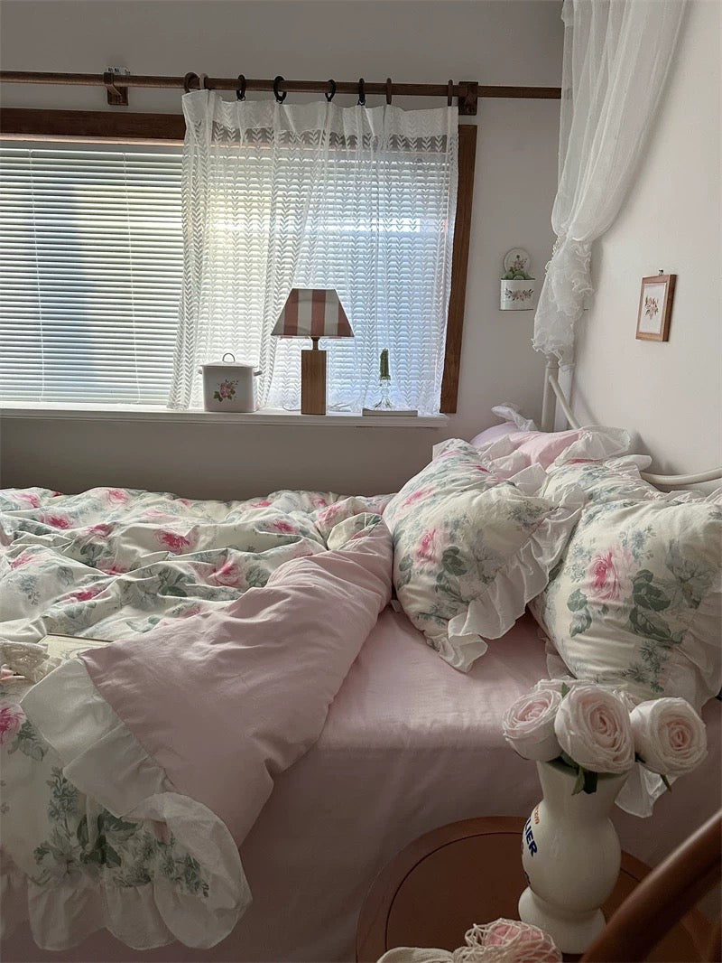 French country bedroom featuring a pink rose duvet cover and ruffled edges.