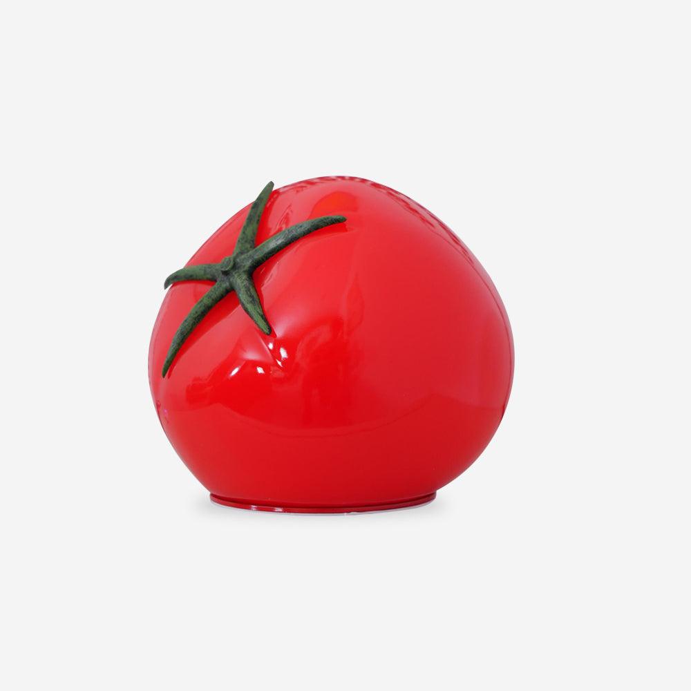Red tomato-shaped object with green stem on a white background