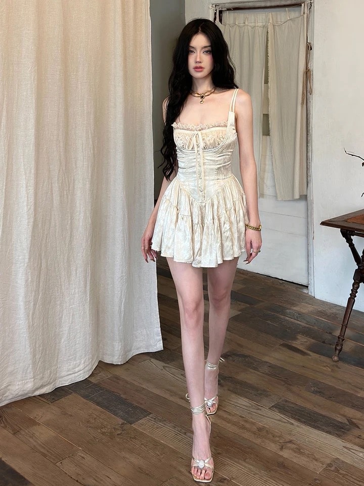 Cream beige coquette aesthetic mini dress with corset waist and lace trim. Backless summer satin dress for parties and special events.