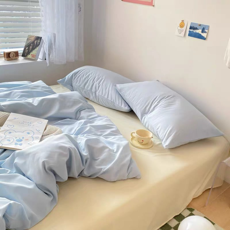 Minimalist cream and blue bedding styled with aesthetic pastel decor.