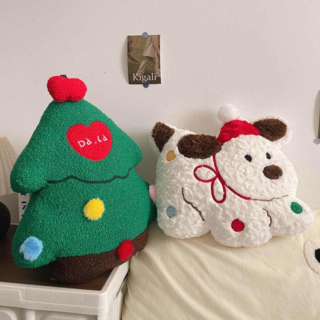 Christmas tree, gingerbread man and Santa puppy plush pillows arranged together on a sofa