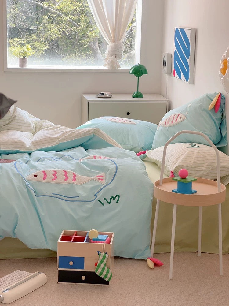 Cute blue cotton bedding set with embroidered cartoon fish, styled in a kawaii dorm room.