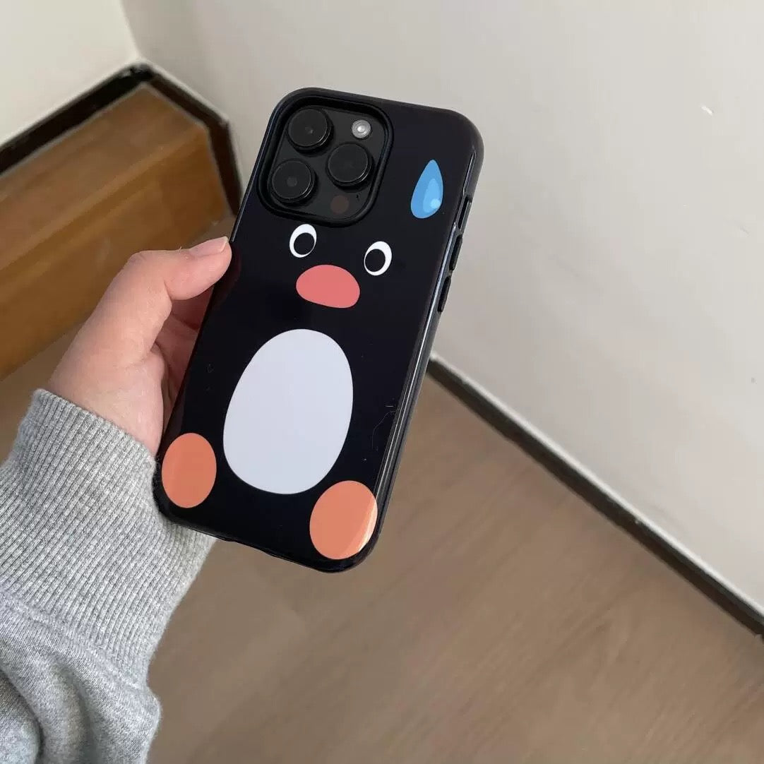 Phone case with a cartoon penguin design held by a person