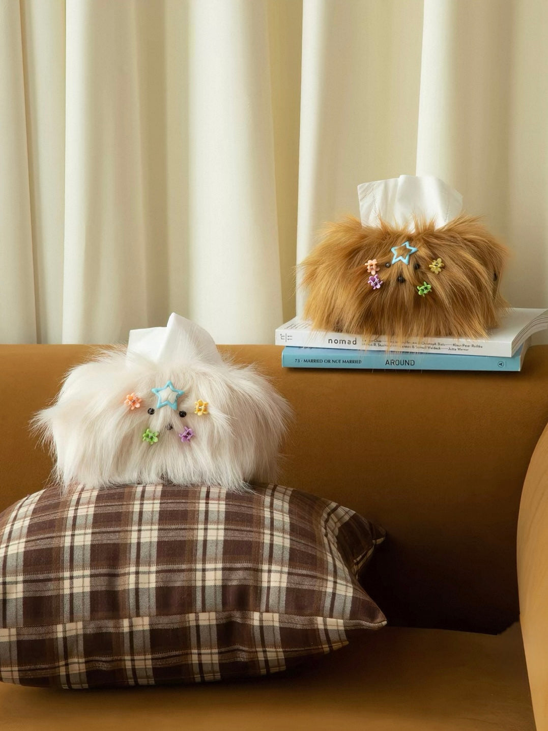 Plush tissue box covers in Cream White and Caramel sit on blue pillows, with pink and blue bows above their faces.