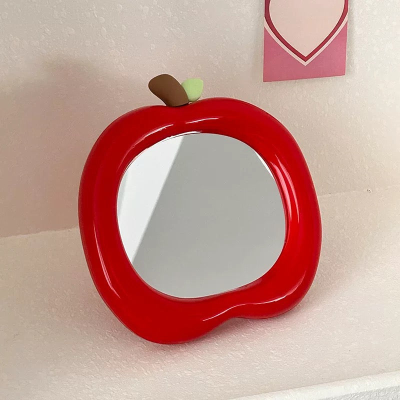 Kawaii green apple mirror for bedroom decor on a pastel-themed surface