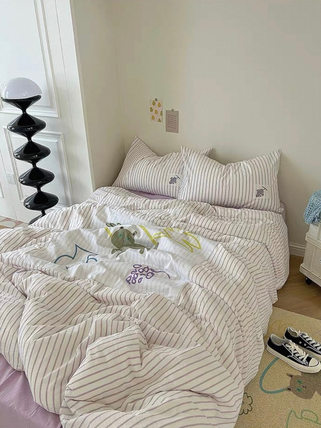 Purple applique duvet cover set with lilac stripes and cartoon patch motifs on a full bed.