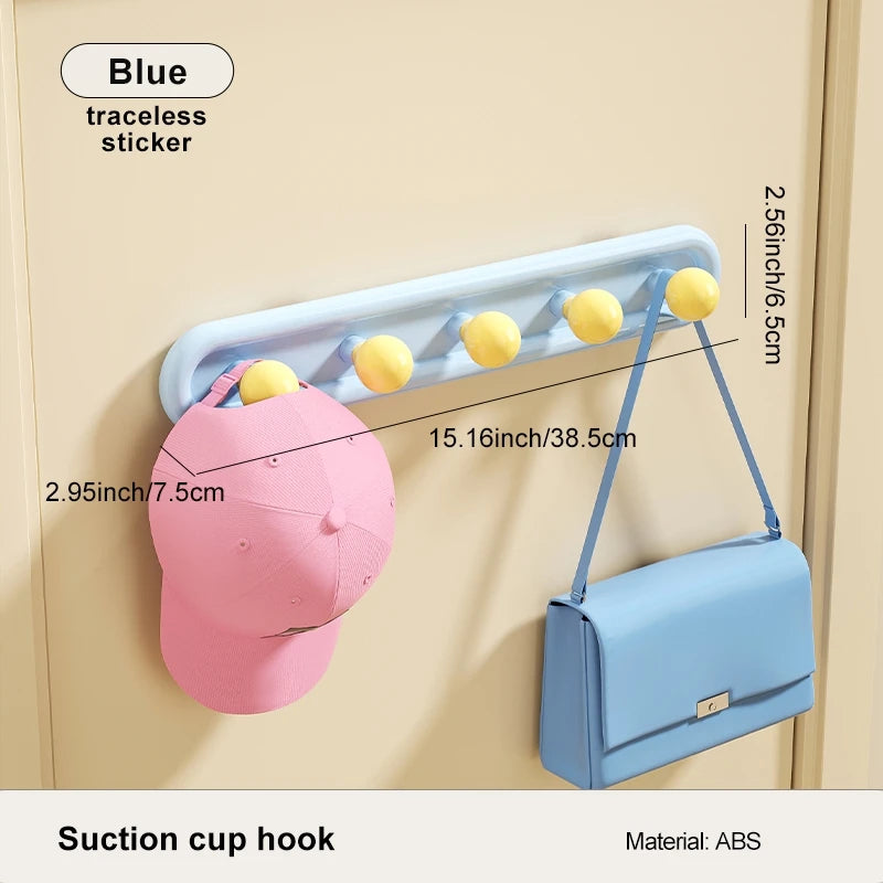 Suction cup hook with a pink cap and blue handbag on a beige background