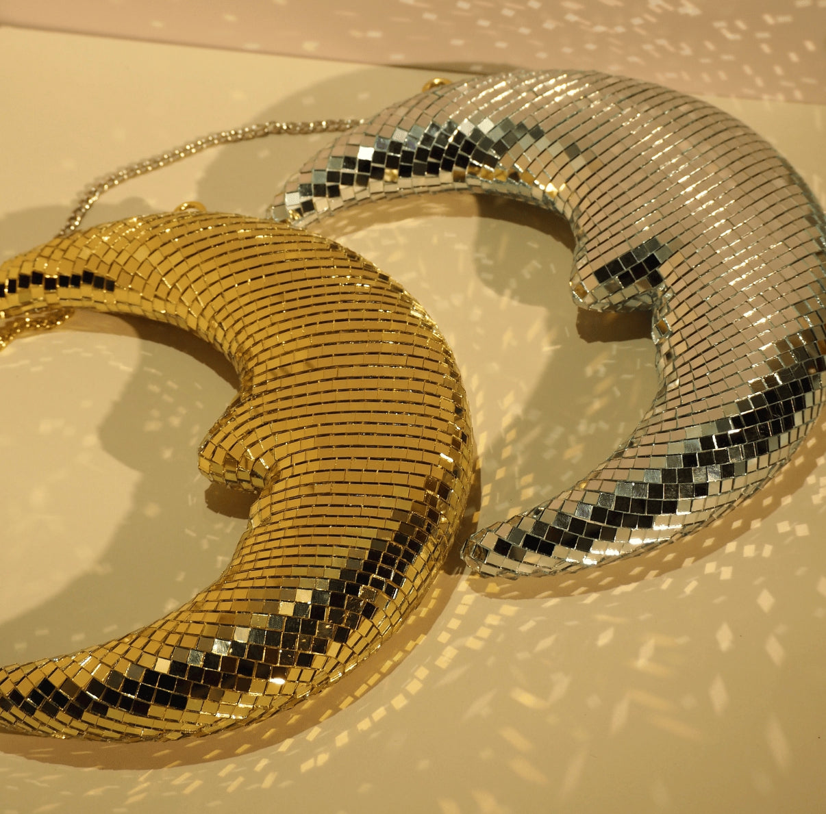 Crescent moon mirrorball hanging with sparkles on wall