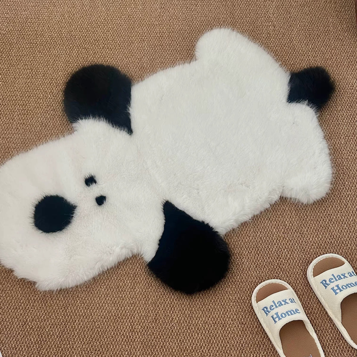A white dog shaped rug with black ears and paws lies flat, showing the full outline and small dark eyes.