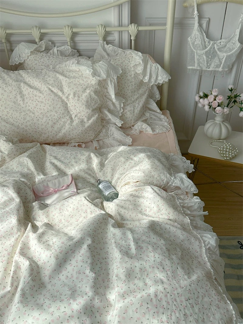 Bed with white floral bedding in a bedroom setting