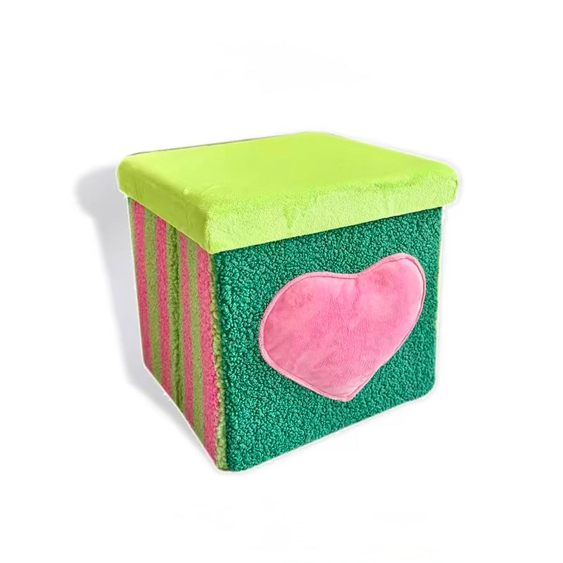 Green heart velvet storage stool on a white background