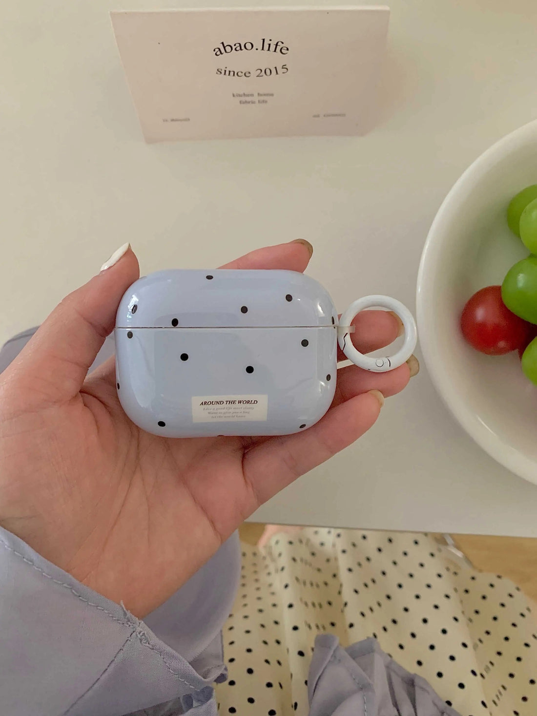 Blue AirPods case with minimalist dot pattern