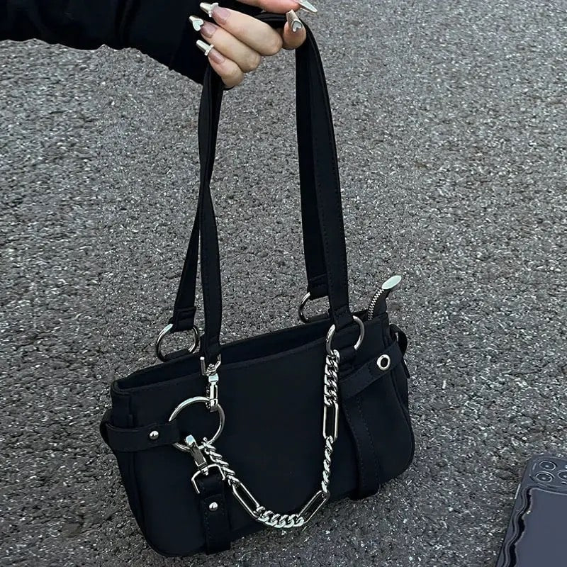 Solid color black handbag with punk and edgy style