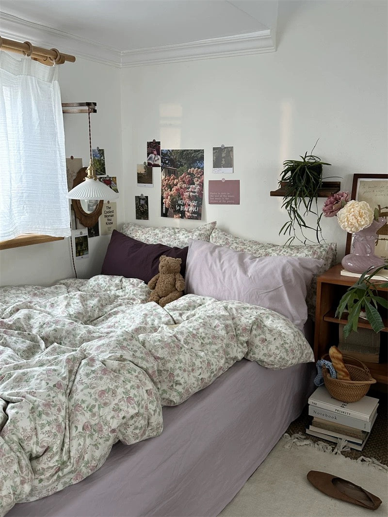 Soft cotton floral bedding displayed with romantic blush pillows creating elegant French country inspired sleeping environment indoors.
