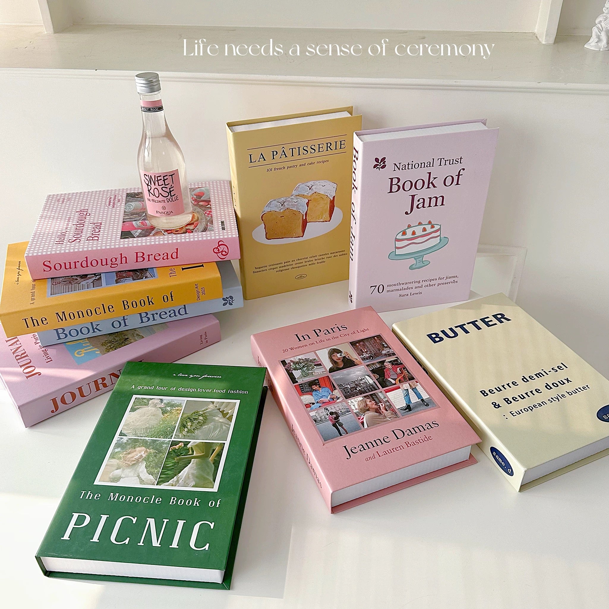 Collection of books on a white surface with a bottle of Svedka Vodka.